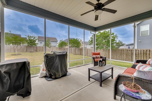 sunroom / solarium featuring a wealth of natural light, a ceiling fan, and an outdoor hangout area