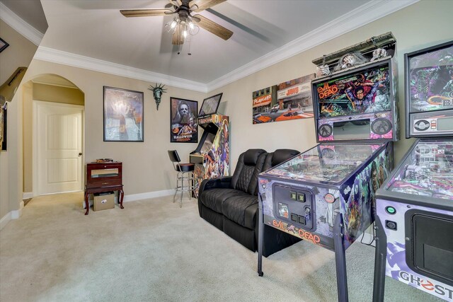 game room featuring carpet flooring, baseboards, a ceiling fan, and crown molding