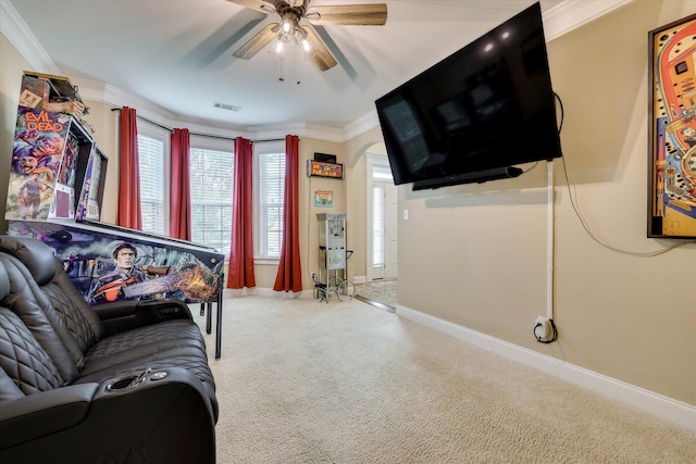 living area with arched walkways, carpet, ceiling fan, visible vents, and crown molding