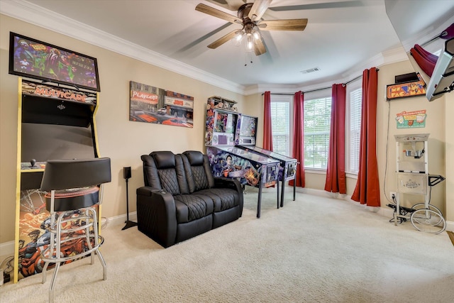 carpeted living area featuring ornamental molding, visible vents, ceiling fan, and baseboards