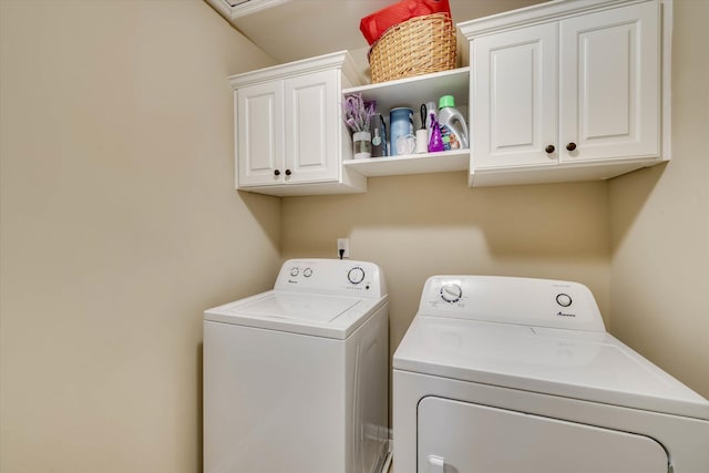 clothes washing area with cabinet space and independent washer and dryer
