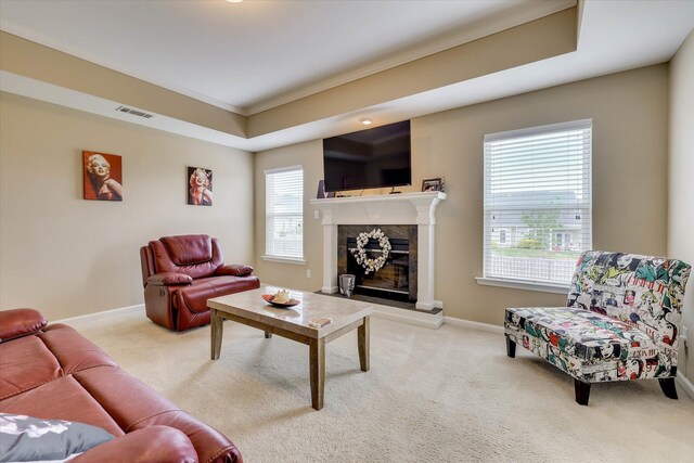 carpeted living room featuring baseboards, visible vents, a high end fireplace, and crown molding