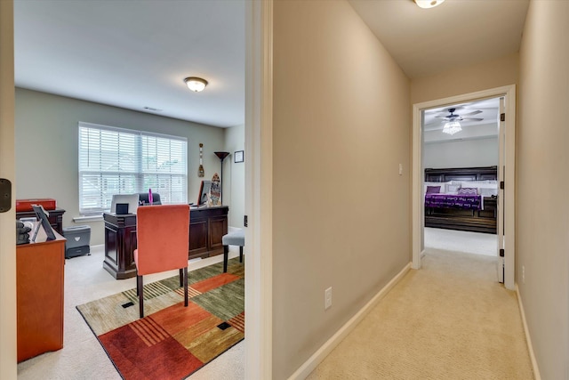 corridor with baseboards and carpet