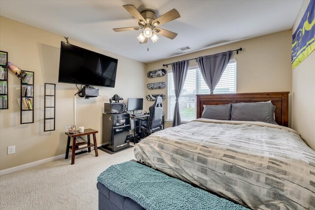 bedroom featuring baseboards, visible vents, ceiling fan, and light colored carpet