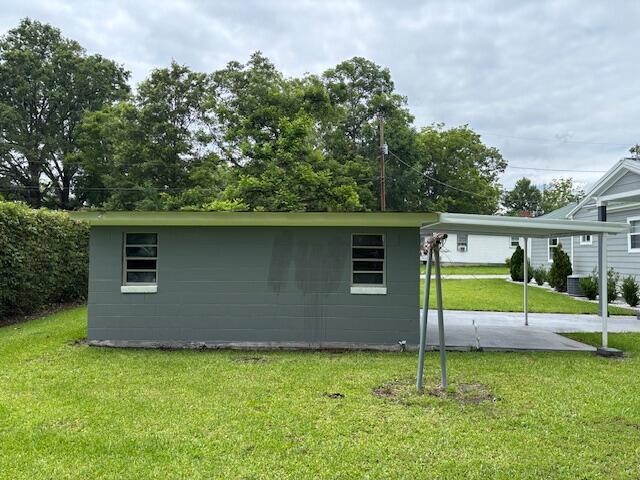 641 Ellington Ave, Thomson, GA 30824 - view of side of property with a yard, a carport, and central AC