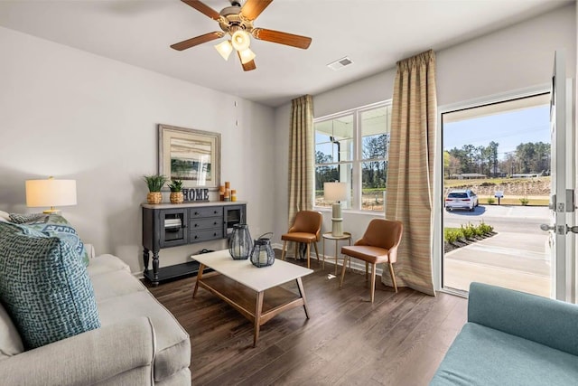 living area with dark hardwood / wood-style flooring and ceiling fan