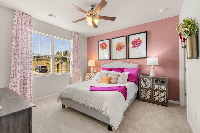 bedroom with ceiling fan and light colored carpet