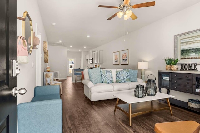 living room featuring ceiling fan and dark wood-type flooring