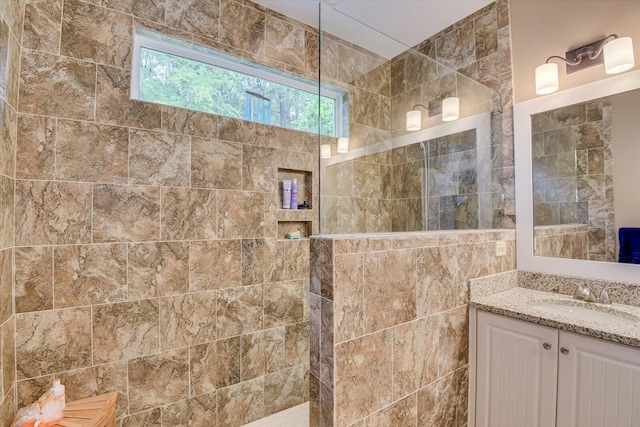 bathroom featuring vanity and tiled shower