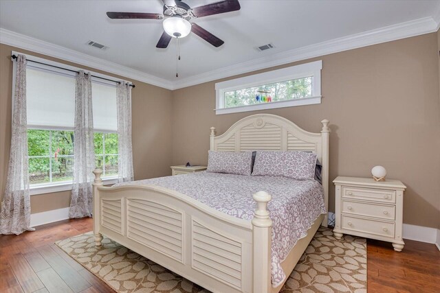 bedroom featuring multiple windows, ceiling fan, and hardwood / wood-style flooring