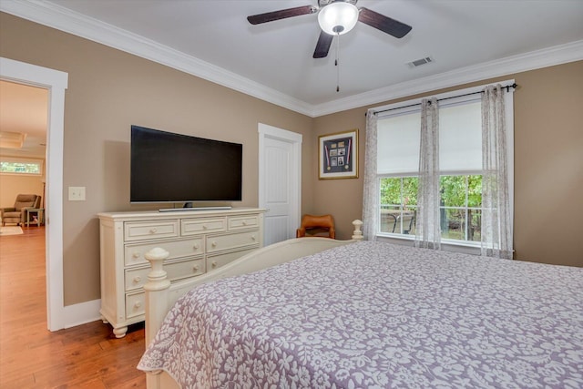 bedroom with light hardwood / wood-style flooring, ceiling fan, and ornamental molding