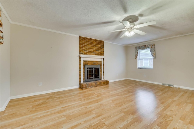 unfurnished living room with crown molding, a fireplace, and light hardwood / wood-style flooring