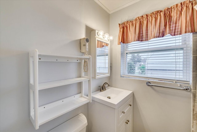 bathroom featuring vanity, ornamental molding, and toilet