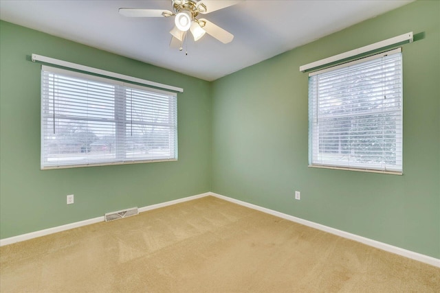 carpeted empty room with ceiling fan