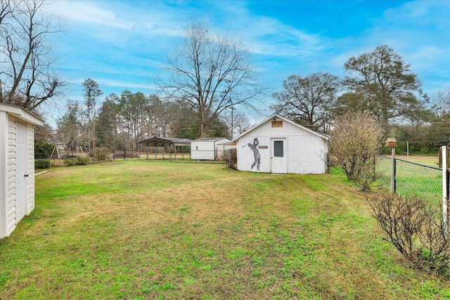 view of yard featuring a carport and a storage shed