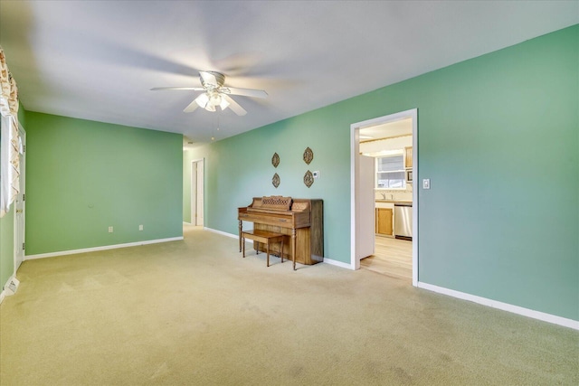 interior space with light colored carpet and ceiling fan