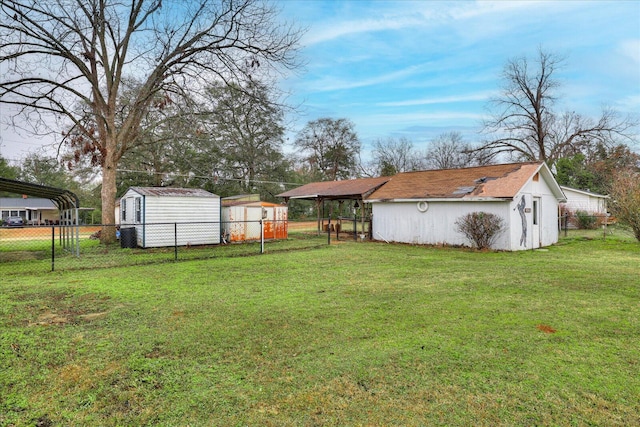 view of yard featuring a carport and a shed