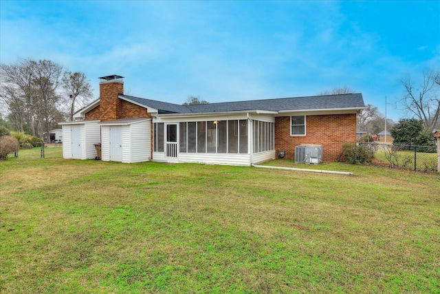 back of house with a yard, central AC, and a sunroom