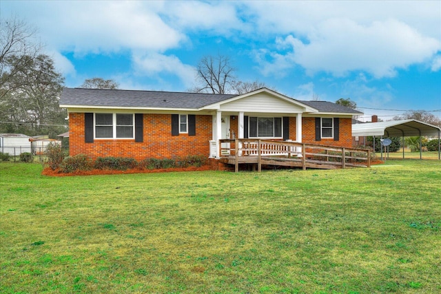 back of property featuring a lawn and a carport