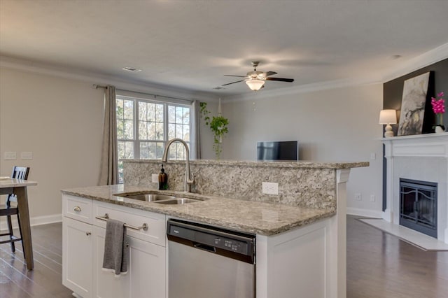 kitchen featuring sink, dishwasher, a kitchen island with sink, light stone counters, and white cabinets