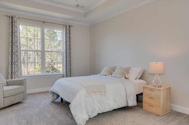 bedroom with multiple windows, a raised ceiling, carpet floors, and crown molding