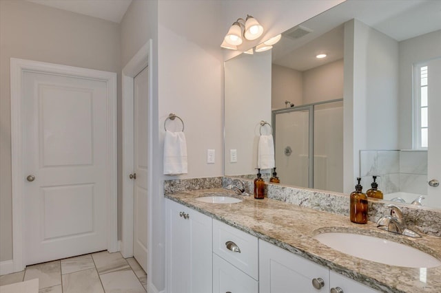 bathroom with vanity and shower with separate bathtub