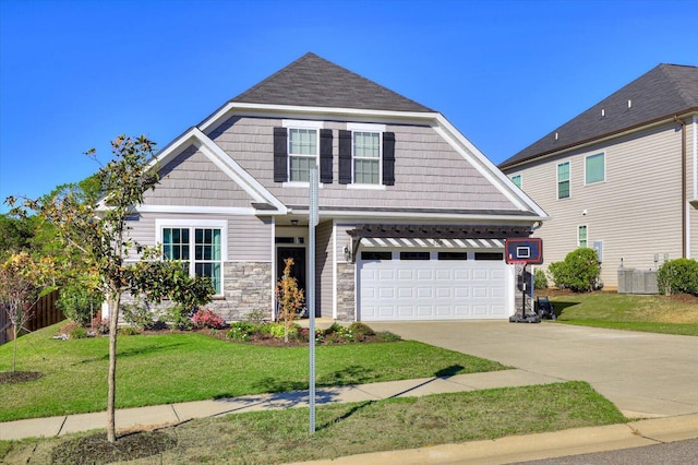 craftsman house featuring a garage, a front yard, and central AC unit