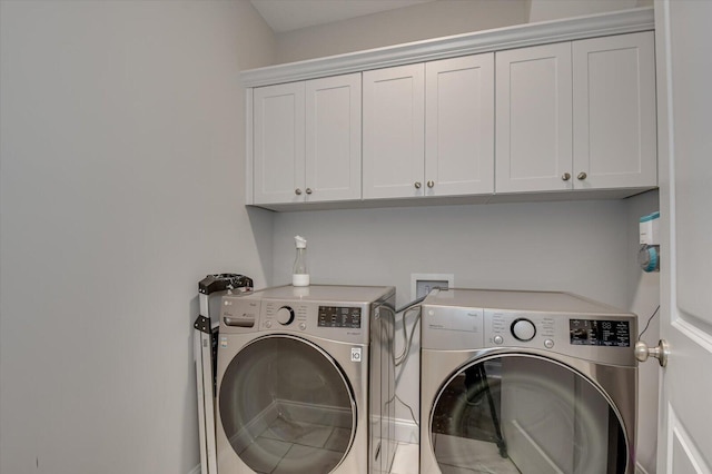 laundry room featuring cabinets and washer and dryer