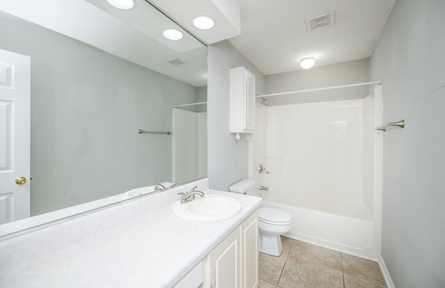 full bathroom featuring shower / bath combination, tile patterned floors, vanity, a textured ceiling, and toilet