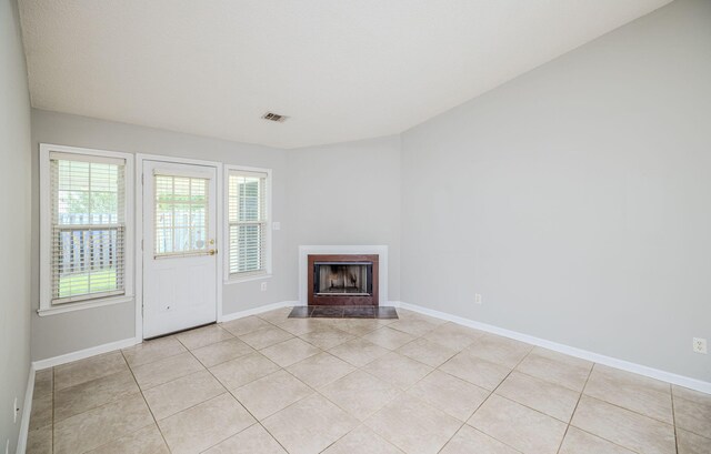 unfurnished living room featuring light tile patterned floors