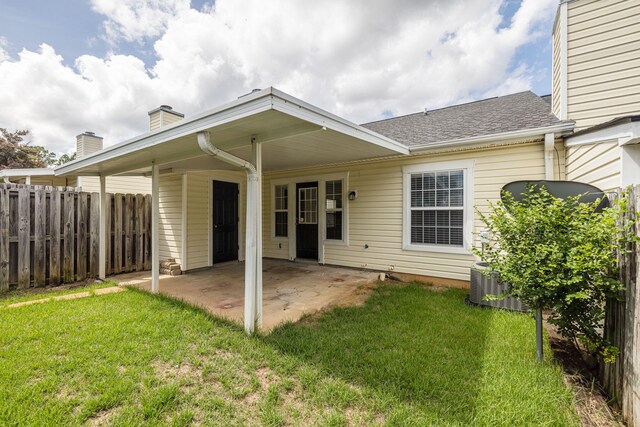 rear view of house with a yard, a patio, and central AC unit