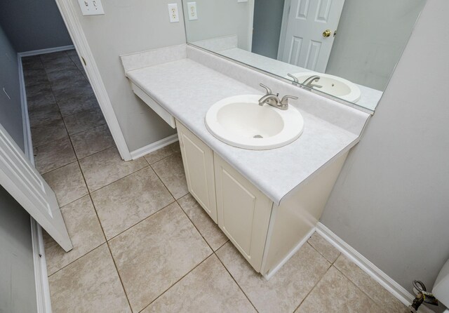 bathroom featuring tile patterned flooring and vanity