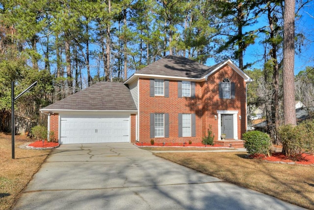 colonial house featuring a garage and a front lawn