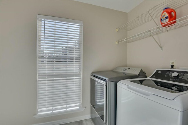 washroom with independent washer and dryer