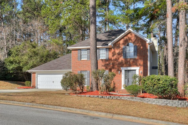 view of front of property featuring a garage and a front yard