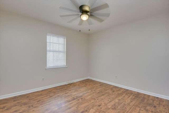 spare room with hardwood / wood-style floors and ceiling fan