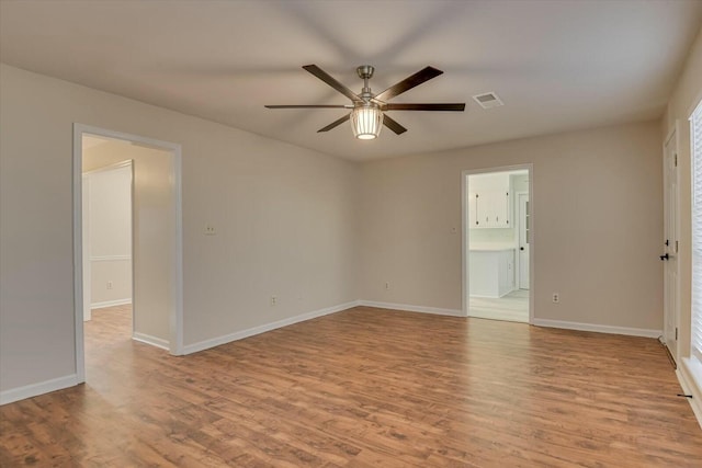 spare room with light hardwood / wood-style flooring and ceiling fan