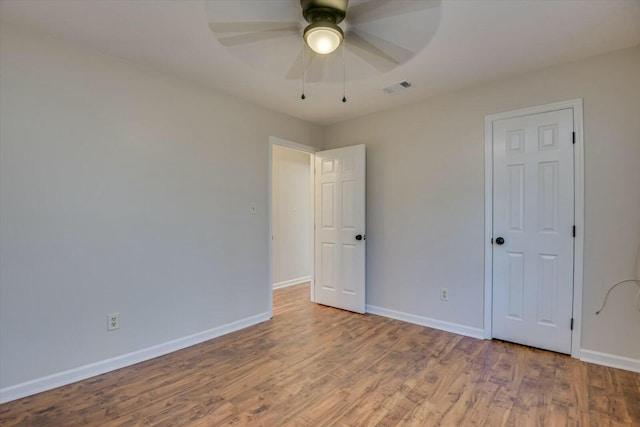 unfurnished bedroom featuring ceiling fan and wood-type flooring