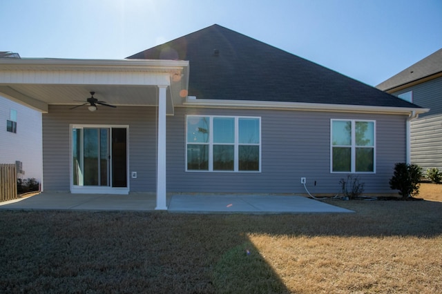 back of property featuring a ceiling fan, a patio area, a yard, and a shingled roof