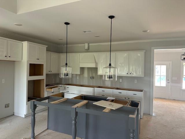 8144 Crossbow Lndg, Graniteville, SC 29829 - kitchen featuring white cabinetry, crown molding, pendant lighting, concrete flooring, and decorative backsplash