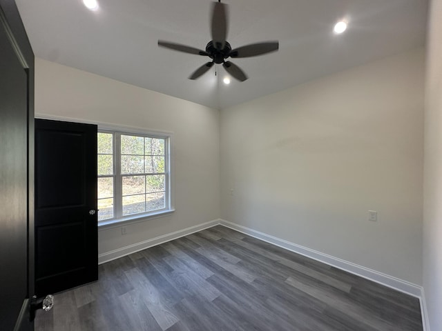 empty room featuring ceiling fan and dark wood-type flooring