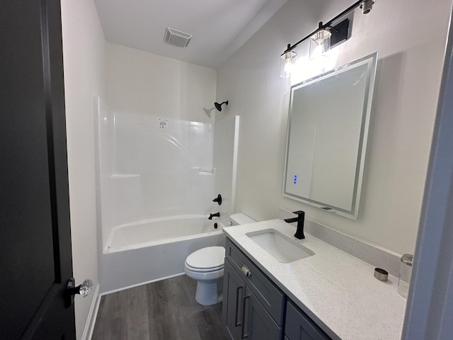 full bathroom featuring hardwood / wood-style floors, vanity, toilet, and shower / bath combination