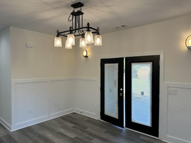 unfurnished room featuring a chandelier, french doors, and dark hardwood / wood-style floors