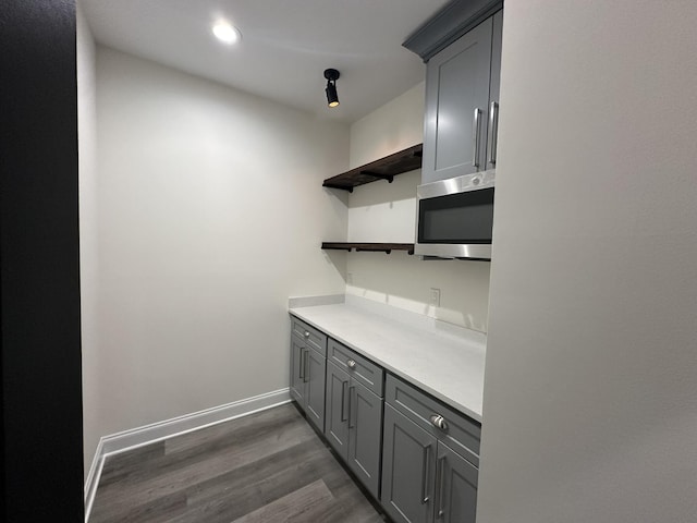 kitchen featuring gray cabinets and dark wood-type flooring