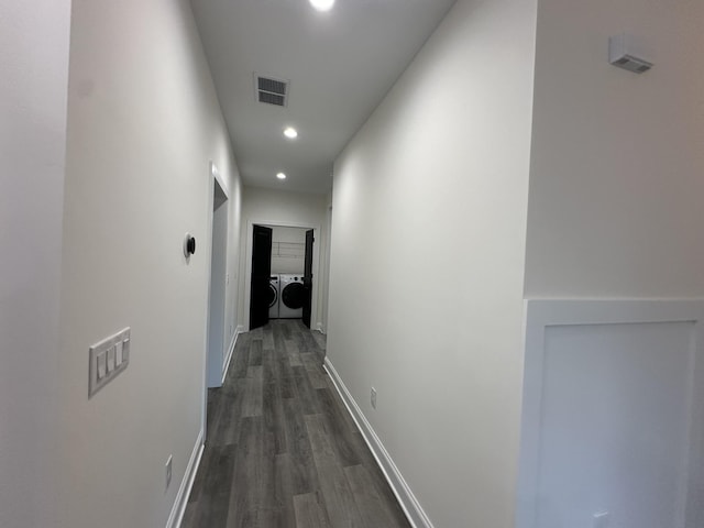 corridor with dark hardwood / wood-style flooring and washer and clothes dryer