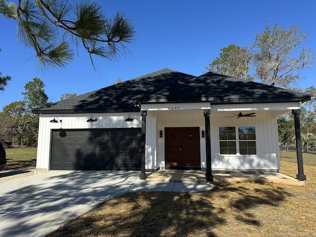 view of front of home with covered porch, ceiling fan, and a garage