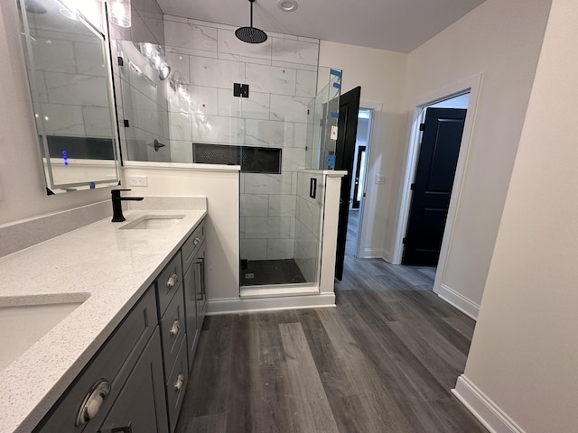 bathroom with vanity, hardwood / wood-style flooring, and a shower with shower door