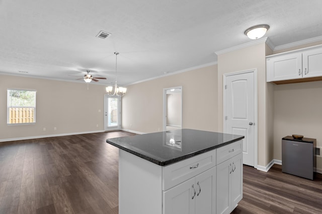 1006 Rosendale Dr, Hephzibah, GA 30815 - kitchen with dark wood-style flooring, white cabinetry, a ceiling fan, ornamental molding, and a kitchen island
