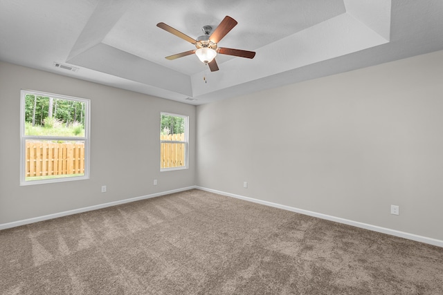 1006 Rosendale Dr, Hephzibah, GA 30815 - empty room featuring a tray ceiling, carpet, and ceiling fan