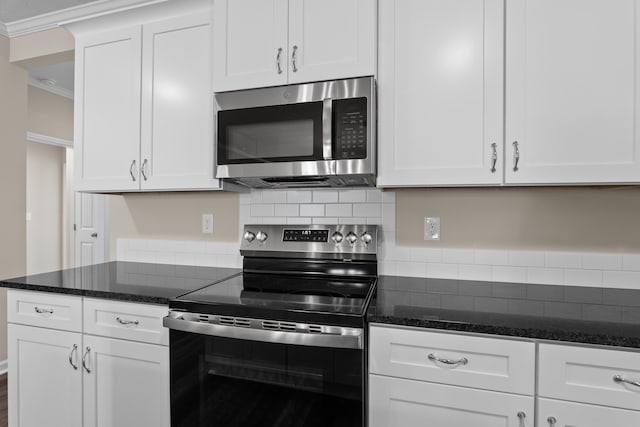 1006 Rosendale Dr, Hephzibah, GA 30815 - kitchen with stainless steel appliances, backsplash, white cabinets, ornamental molding, and dark stone counters